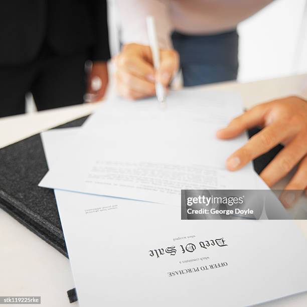 person signing sales documents - ribbon cutting ceremony of new ghirardelli soda fountain and chocolate shop stockfoto's en -beelden