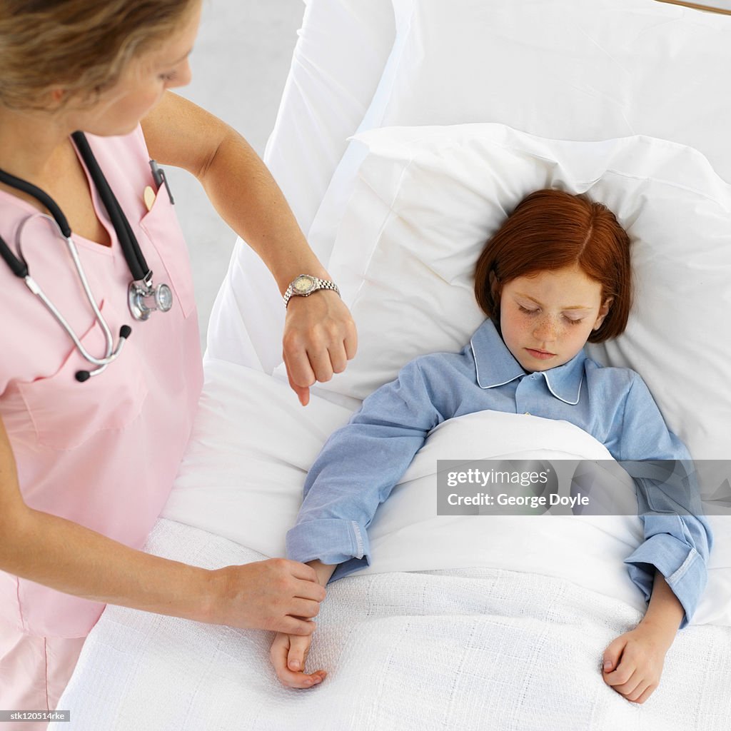 A young female nurse checking a patients pulse