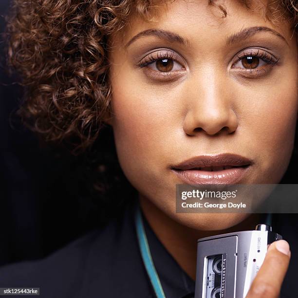 close-up of a young businesswoman holding a dictaphone - ditafone imagens e fotografias de stock