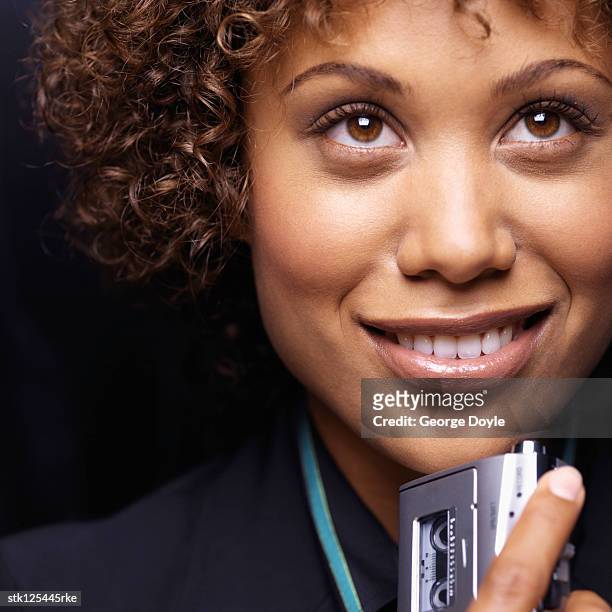 close-up of a young businesswoman holding a dictaphone - ditafone imagens e fotografias de stock