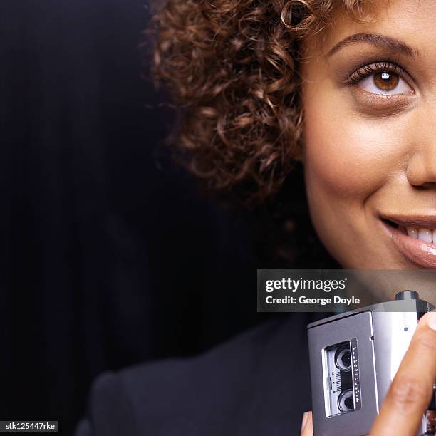 close-up of a young businesswoman holding a dictaphone - 小型テープレコーダー ストックフォトと画像