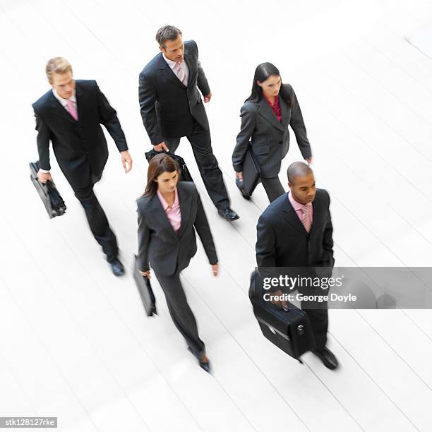 a high angle view of a group of business executives walking with briefcases - black man high 5 stockfoto's en -beelden