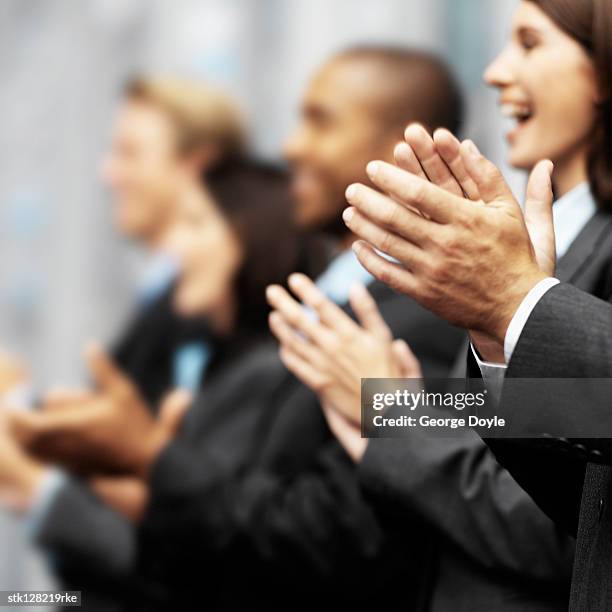 side profile of a group of young executives clapping (blurred) - clapping hands close up stockfoto's en -beelden