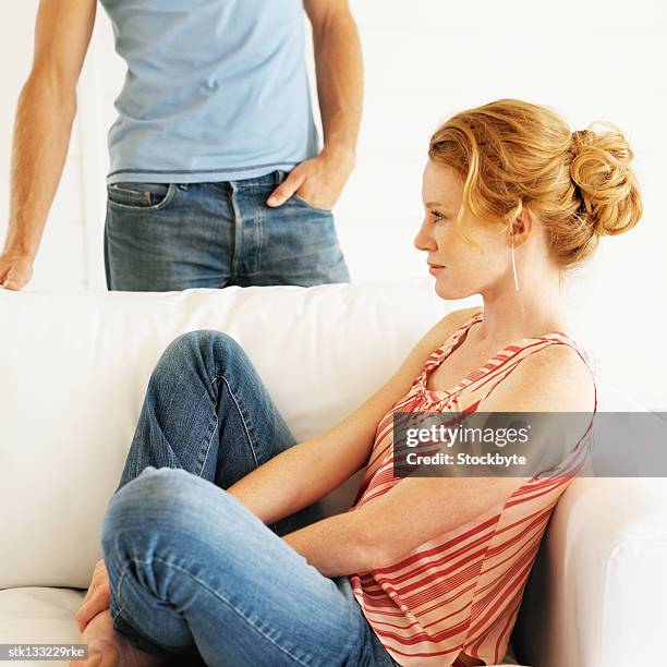 young couple relaxing in living room - living stock-fotos und bilder