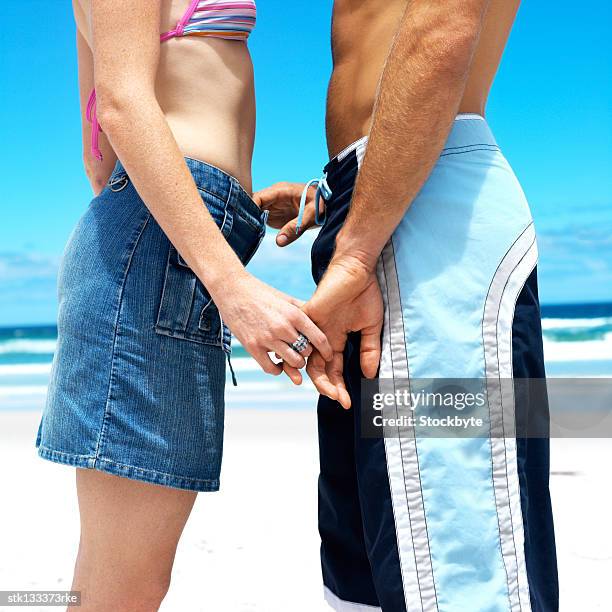 close-up of a couple standing across each other with hands held - across stock pictures, royalty-free photos & images