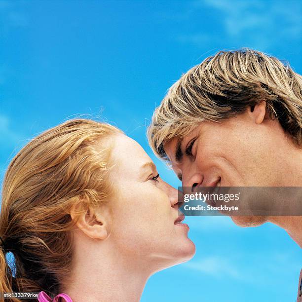 low angle view of a couple about to kiss - about stock pictures, royalty-free photos & images