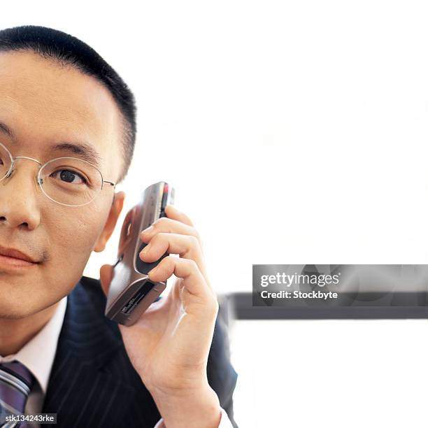 portrait of a businessman holding a cassette recorder up to his ear - dictaphone stock pictures, royalty-free photos & images