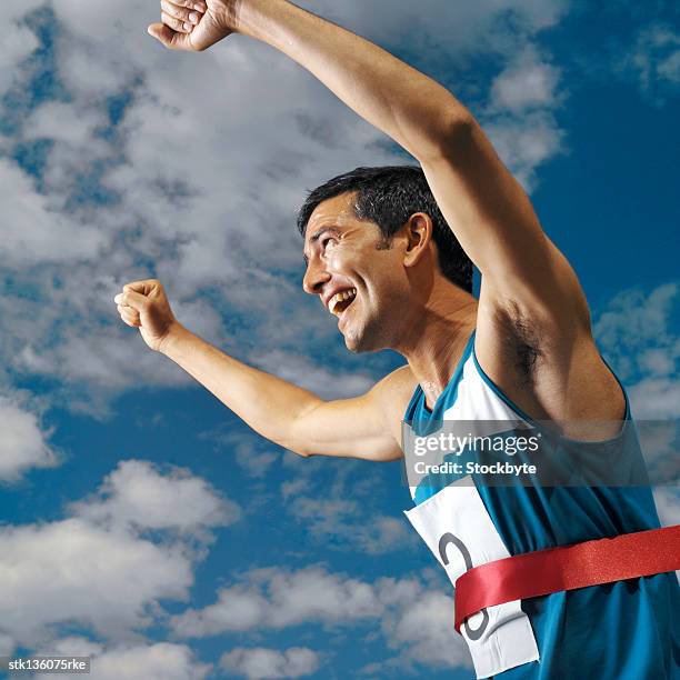 side profile of a man cheering after completing a race - after stock pictures, royalty-free photos & images