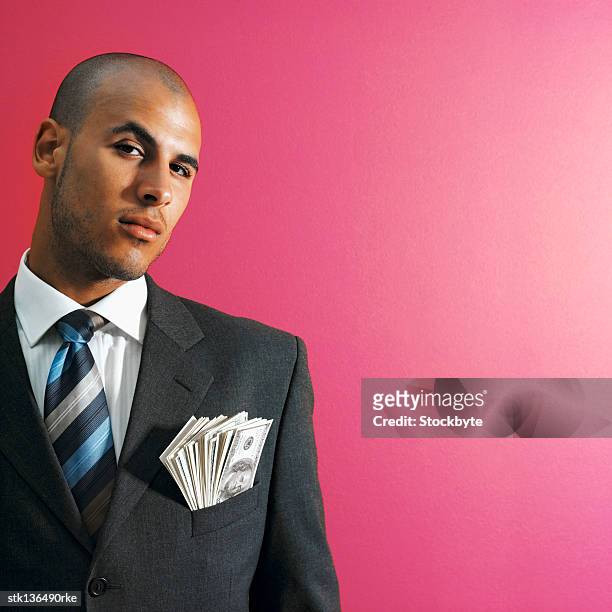 portrait of businessman showing american dollar notes in his pocket - pink colour scheme stock pictures, royalty-free photos & images