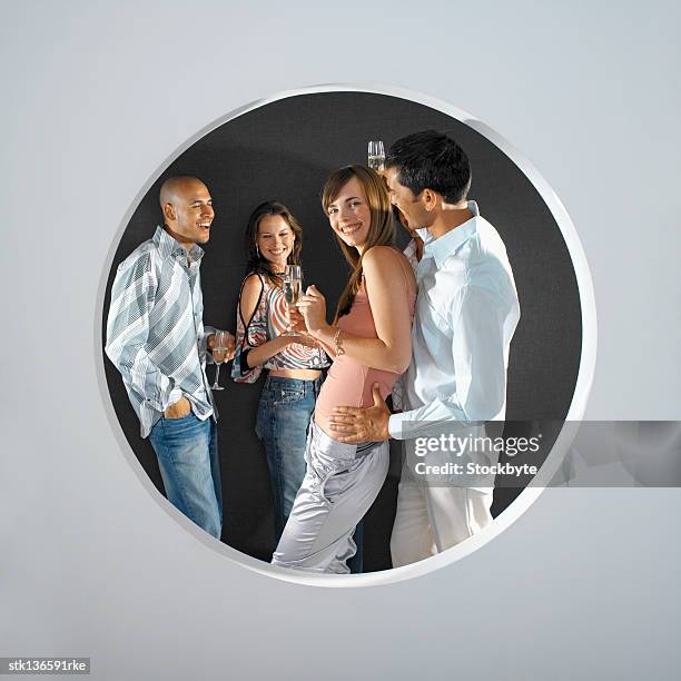 side view of two men and two women holding glasses of champagne - dark haired man gray shirt with wine stock pictures, royalty-free photos & images