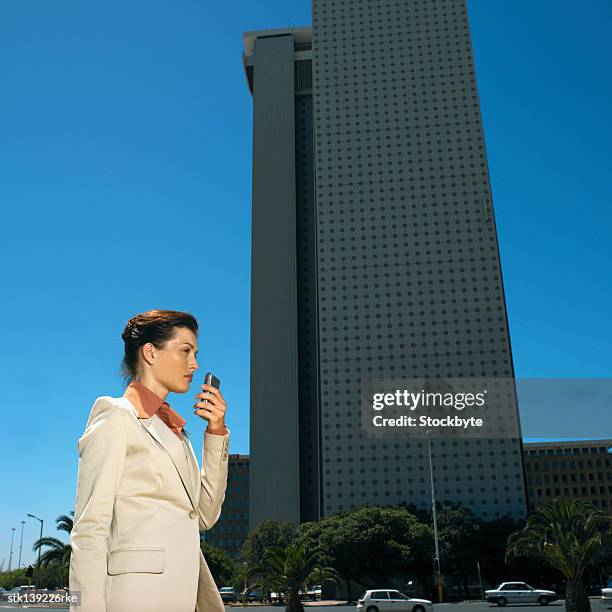 side view of businesswoman talking into dictaphone - dictaphone stock pictures, royalty-free photos & images