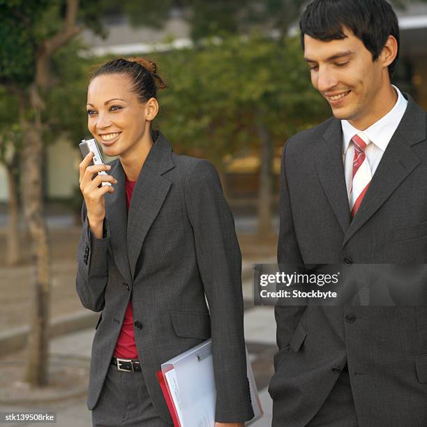 business executives walking and talking together - ditafone imagens e fotografias de stock