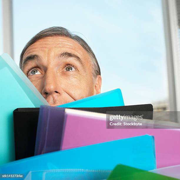 close up of a businessman holding a stack of files - stack foto e immagini stock