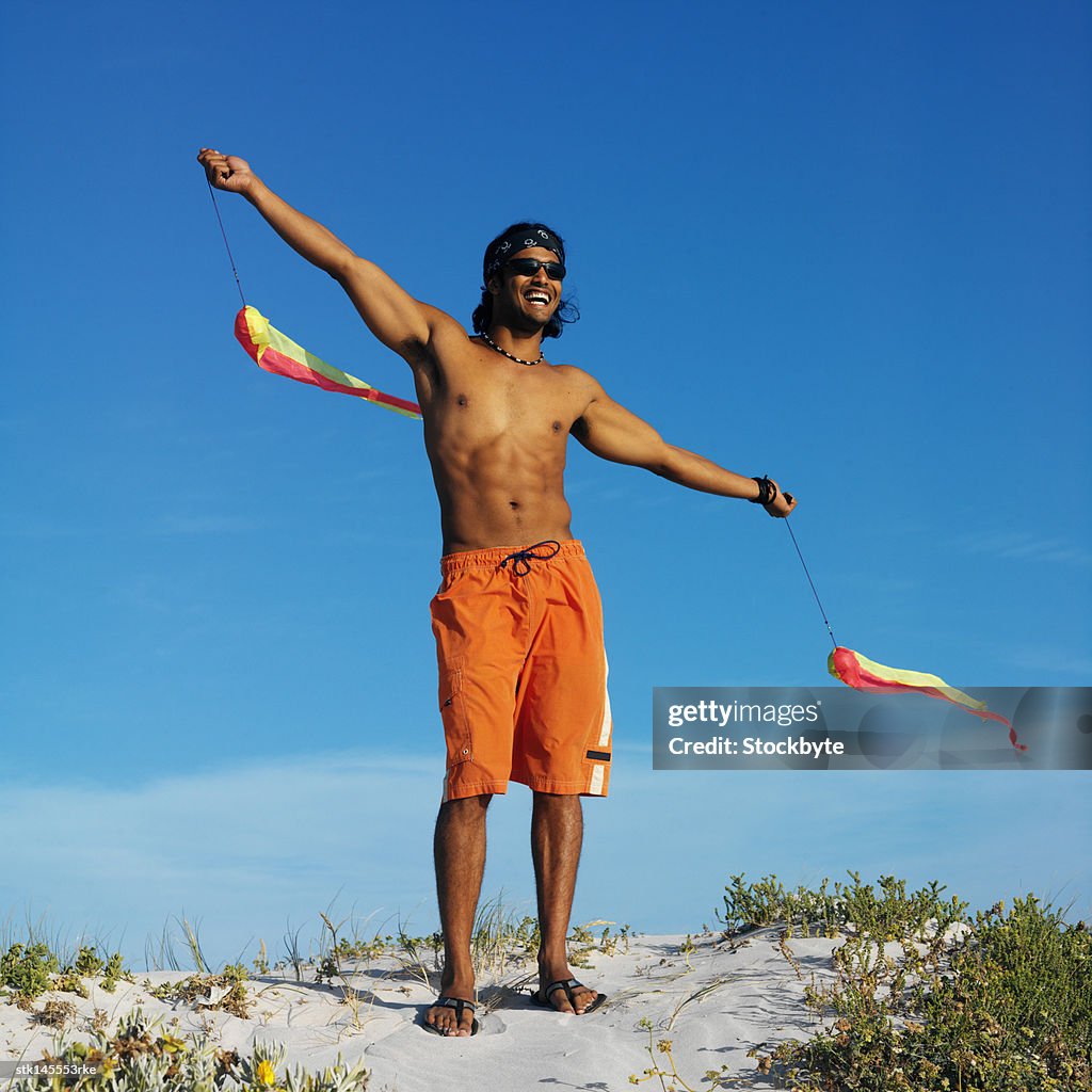 Young man playing with kite