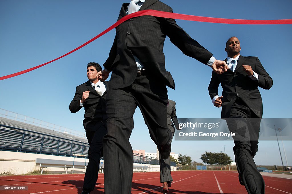 Low angle view of business executives crossing the finish line