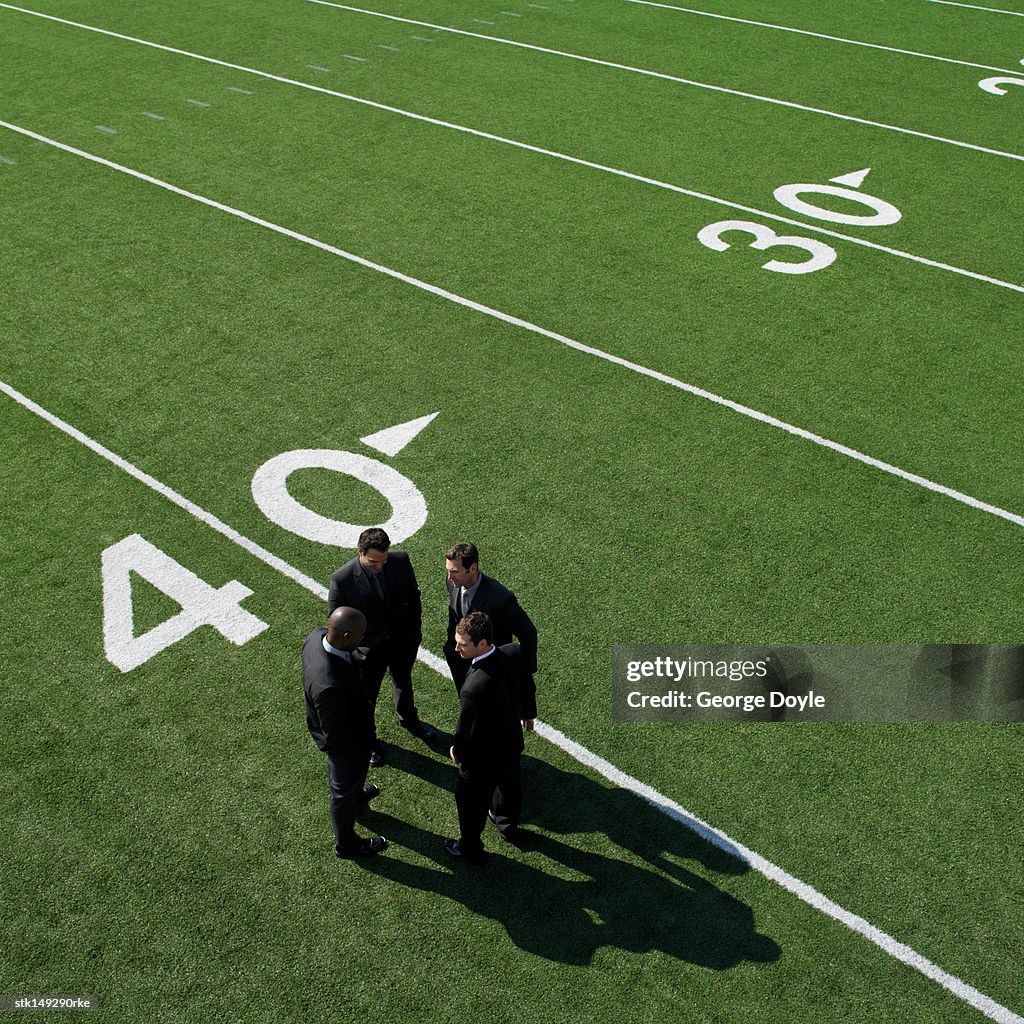 Businessmen on sports field, elevated view