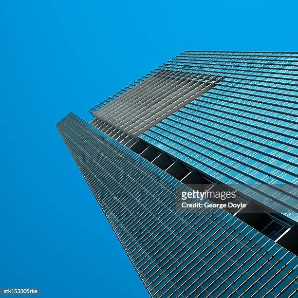 low angle view of a high rise office building - high and low stockfoto's en -beelden