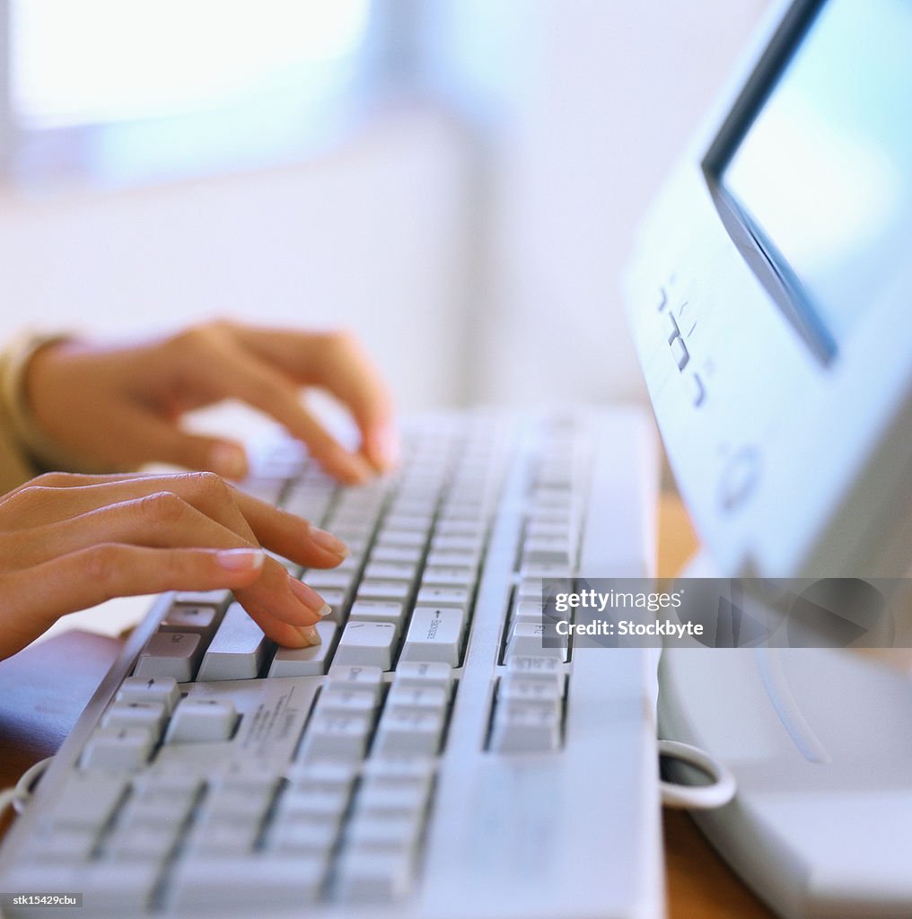 Close-up of hands using a keyboard