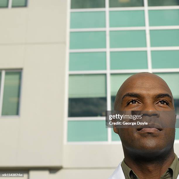 young male microbiologist standing outdoors looking ahead - ahead stock pictures, royalty-free photos & images