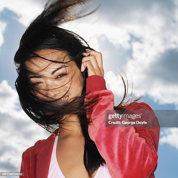 portrait of young woman smiling with hair across her face - across stock pictures, royalty-free photos & images