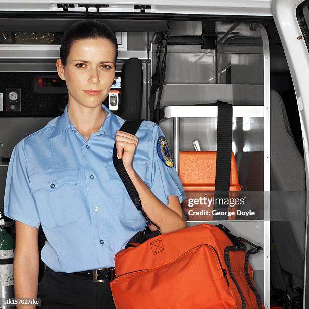 portrait of a young paramedic standing inside an ambulance - inside of ストックフォトと画像