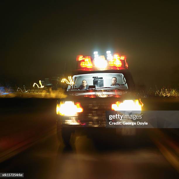 an ambulance on the road at night with two young paramedics inside (blurred) - awareness film festival opening night premiere of the road to yulin and beyond arrivals stockfoto's en -beelden