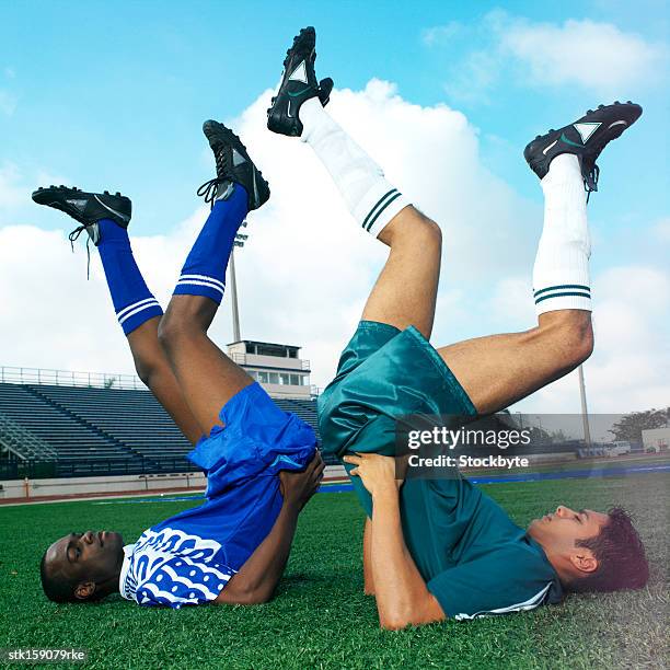 two football players exercising - human powered vehicle stock pictures, royalty-free photos & images