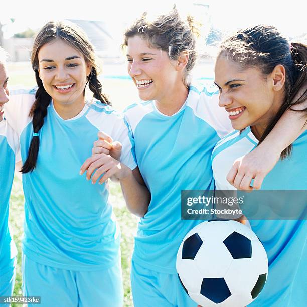 four female soccer players (16-18) smiling with arms around one another - aother stock pictures, royalty-free photos & images