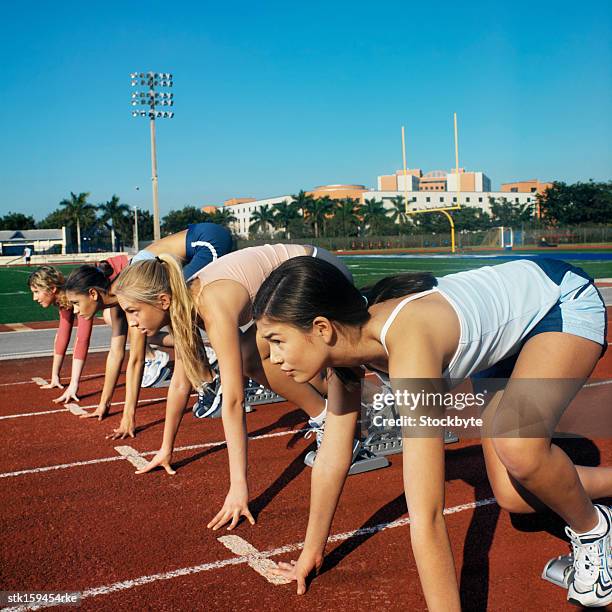 teenage girls at starting positions in a field race - só meninas adolescentes imagens e fotografias de stock