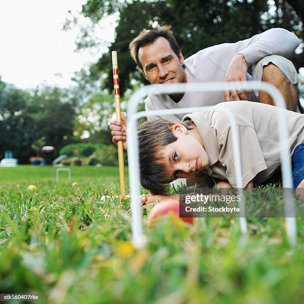 father and son playing croquet - croquet fotografías e imágenes de stock