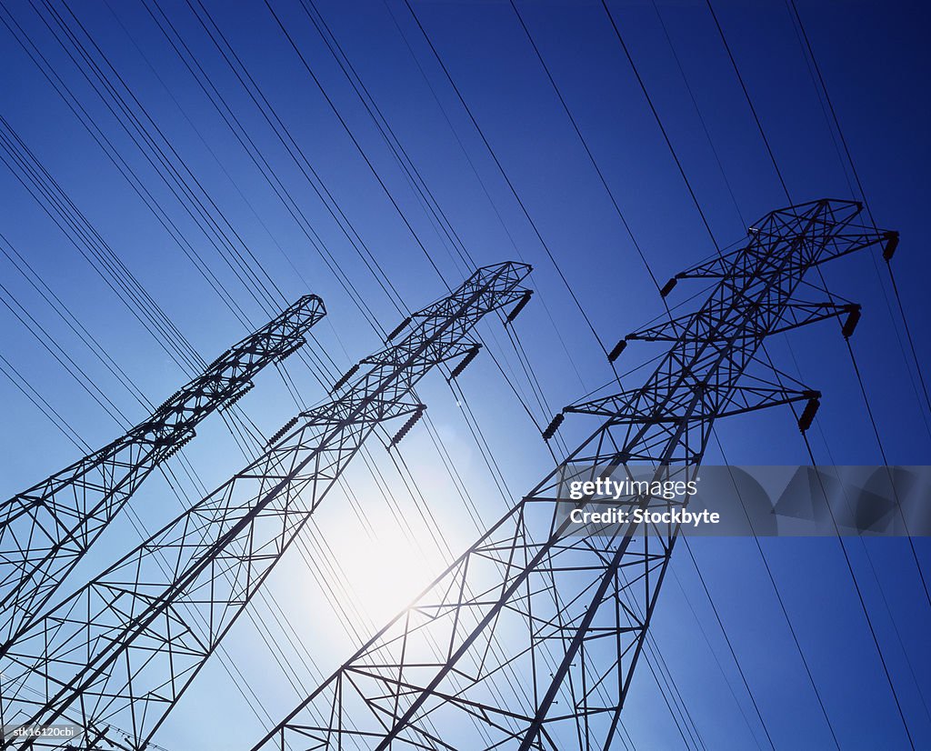 Low angle view of high tension cable towers