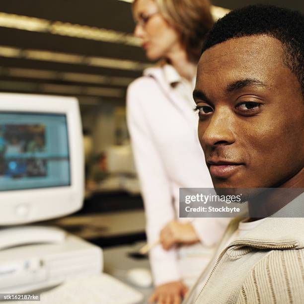 portrait of a young man at a computer station - university of california students protest 32 percent fee hike stockfoto's en -beelden