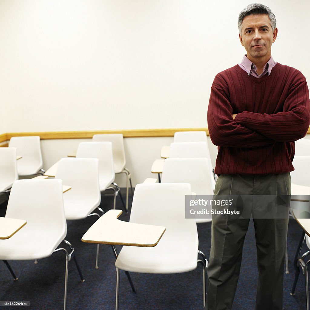 Portrait of an elderly man standing in a classroom