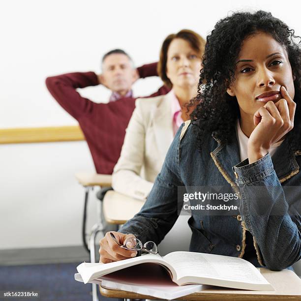 adult students paying attention in class - university of california students protest 32 percent fee hike stockfoto's en -beelden