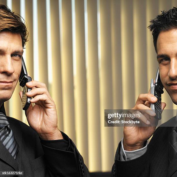 two businessmen using mobile phones - informational stock pictures, royalty-free photos & images