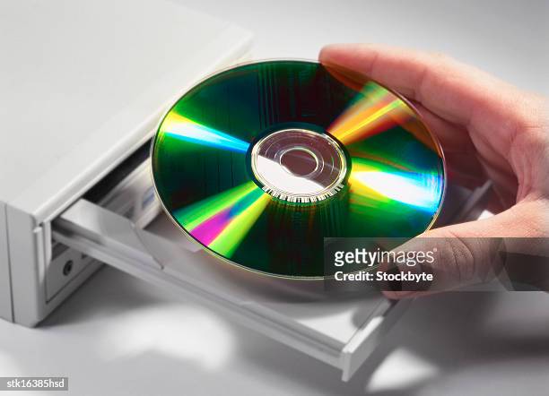 close-up of a hand inserting a compact disc into a drive - installation of memorial honors victims of ghost ship fire in oakland stockfoto's en -beelden
