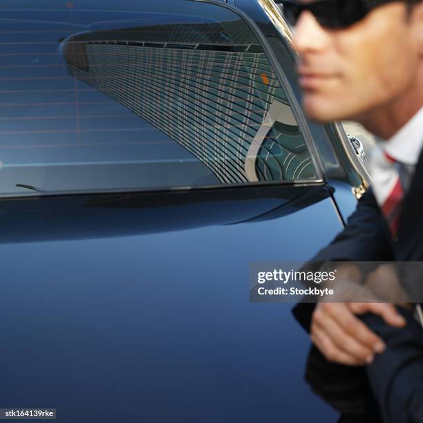 reflection of a skyscraper an a car windscreen - reflection foto e immagini stock