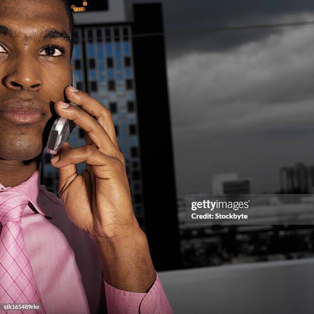 low angle close up view of businessman talking on mobile phone - pink colour scheme stock pictures, royalty-free photos & images