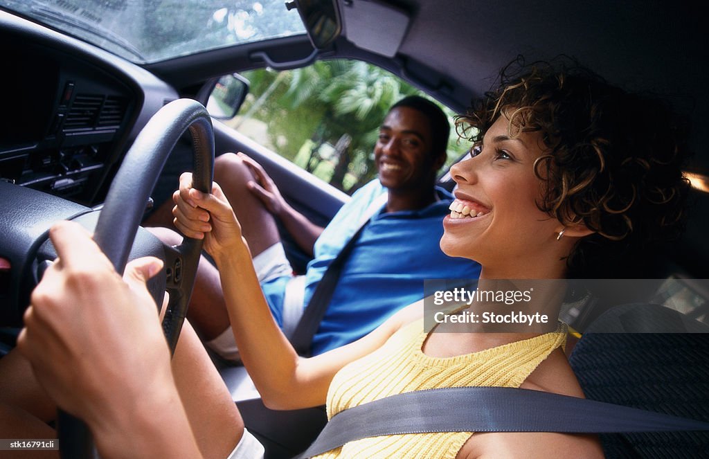 Side profile of a woman driving with a man sitting next to her