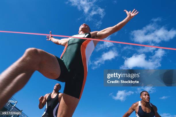 low angle view of a young male athlete crossing the finish line first - national archives foundation honor tom hanks at records of achievement award gala stockfoto's en -beelden