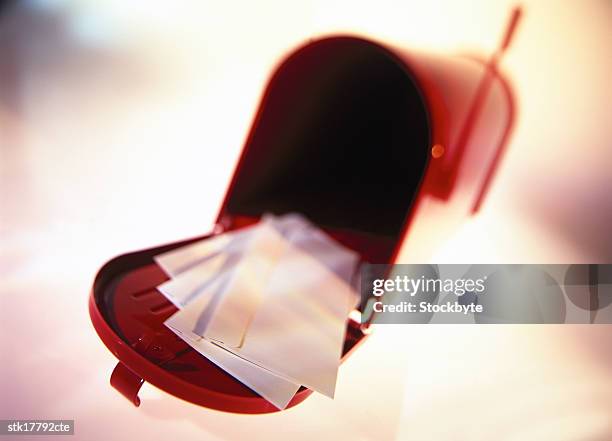 close-up of an open letterbox with mail in it - letterbox stock-fotos und bilder