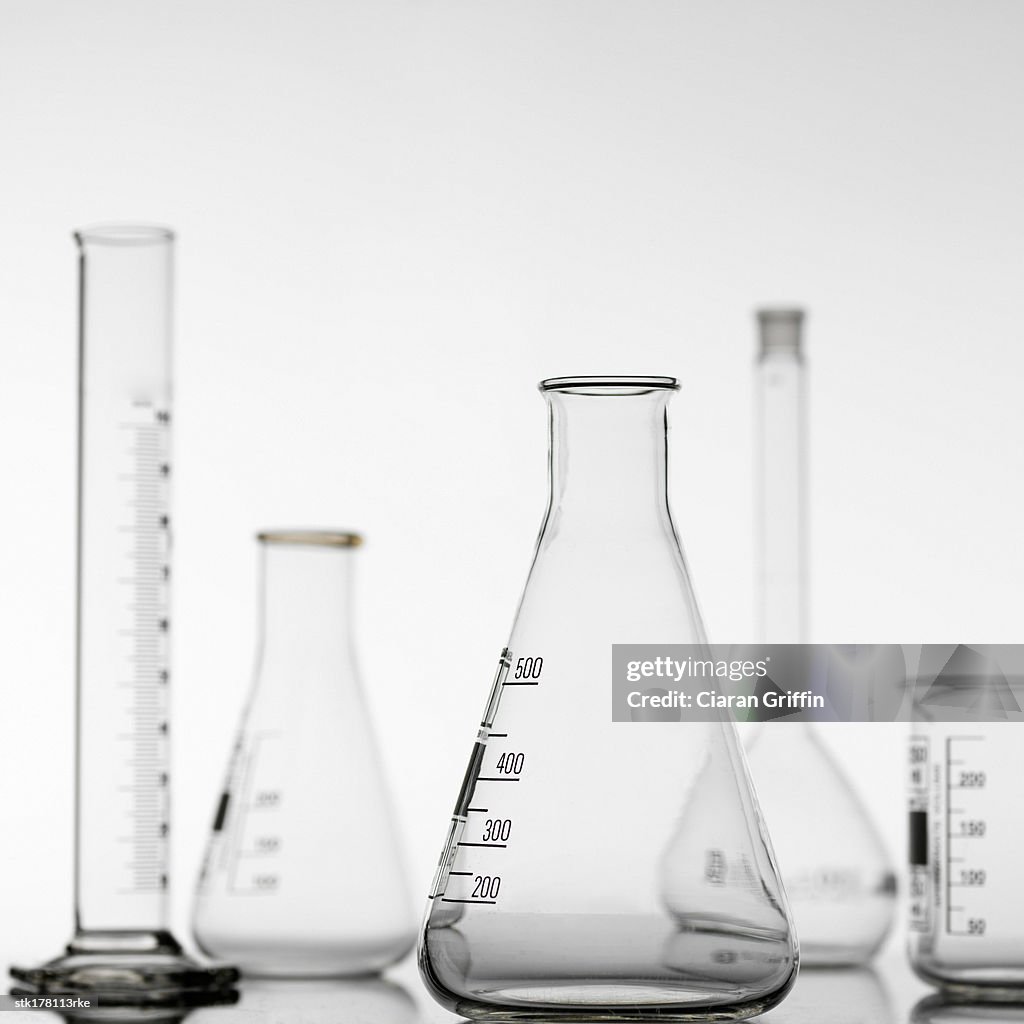 A variety of glass beakers and test tubes placed on a table