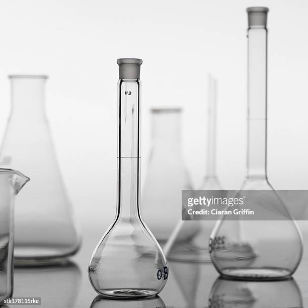 a variety of glass beakers placed on a table - variety bildbanksfoton och bilder