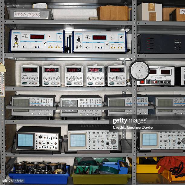 electronic laboratory devices on shelves - oscilloscope stock pictures, royalty-free photos & images