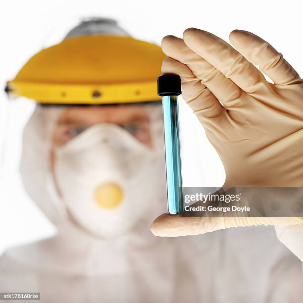 scientist in full protective gear holding test-tube - unveiling of life size statue of andrea bocelli at keep memory alive event center stockfoto's en -beelden