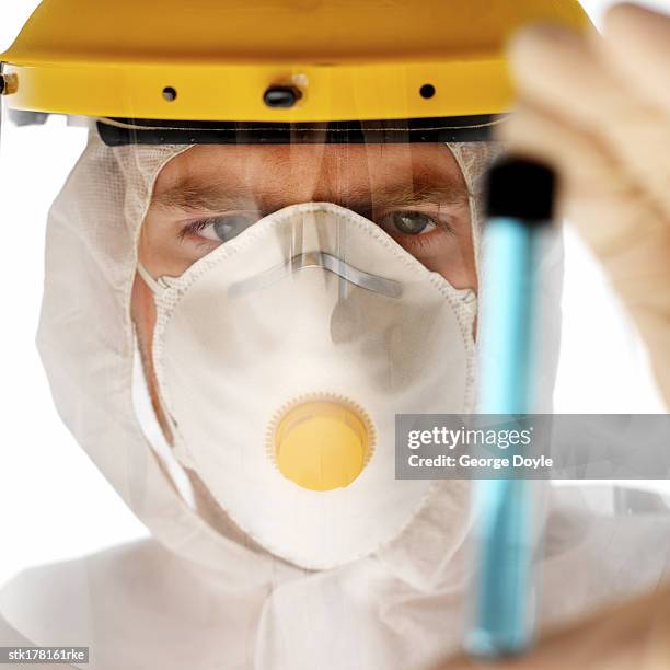 close-up of a scientist in full protective gear holding test-tube - unveiling of life size statue of andrea bocelli at keep memory alive event center stockfoto's en -beelden
