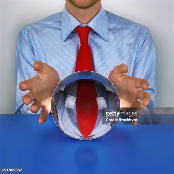 person sitting in front of a crystal ball - crystal stock-fotos und bilder