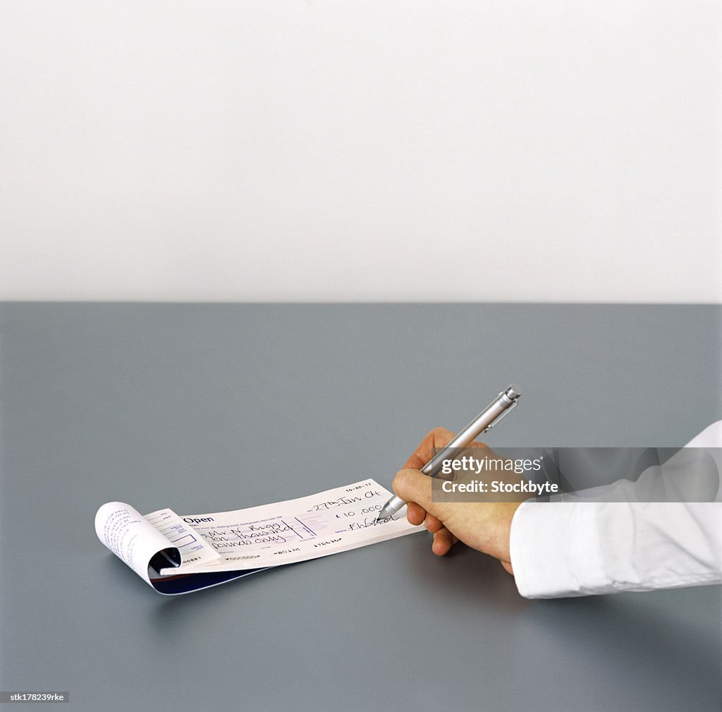Sign A Cheque Person Signing A Cheque High-Res Stock Photo - Getty Images