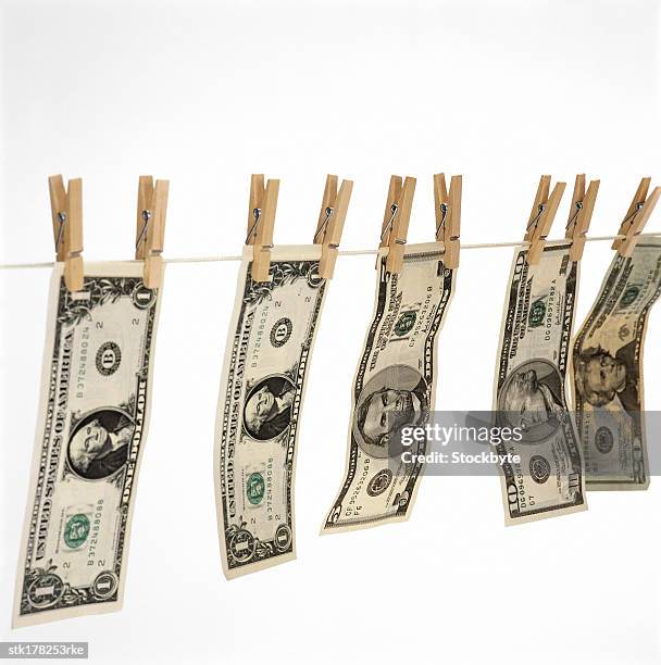 dollar bills hanging on a clothes line held by clothes pegs - five dollar bill stock pictures, royalty-free photos & images