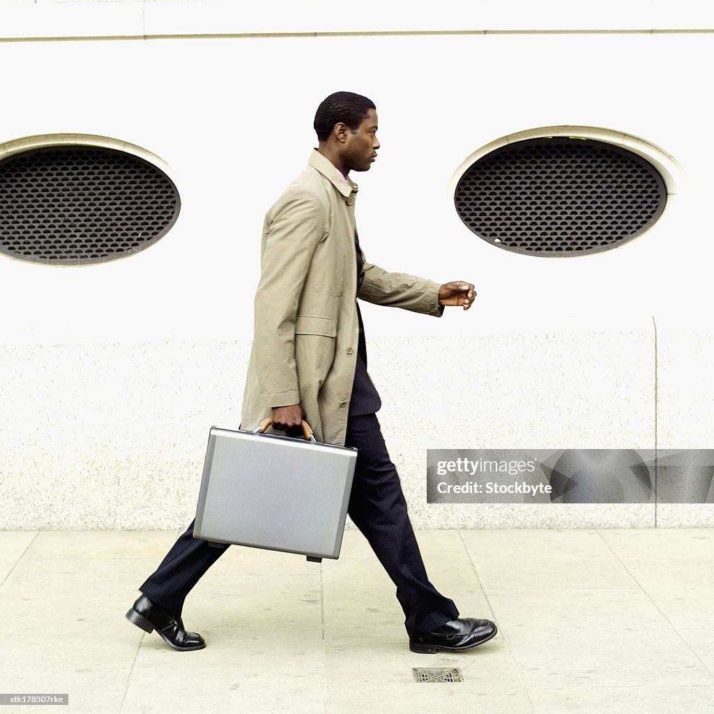 Side view of businessman holding briefcase